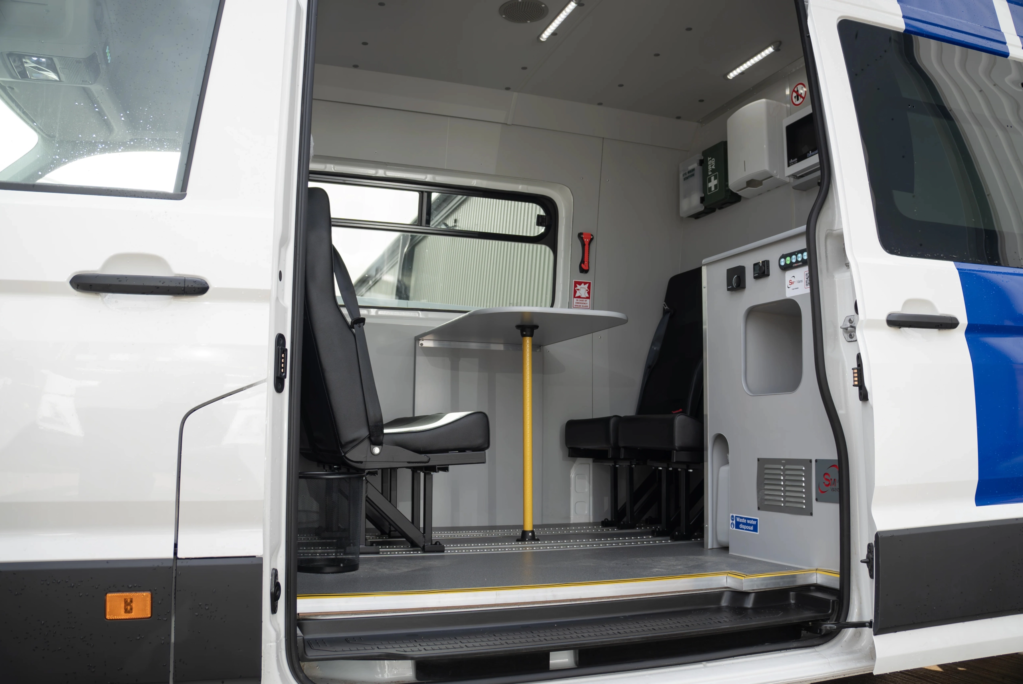 View into he side of a Welfare van showing table and chairs