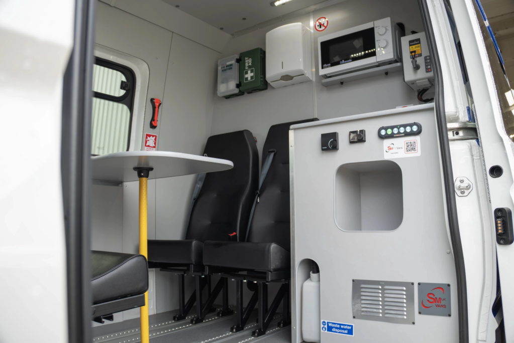 View into he side of a Welfare van showing table and chairs