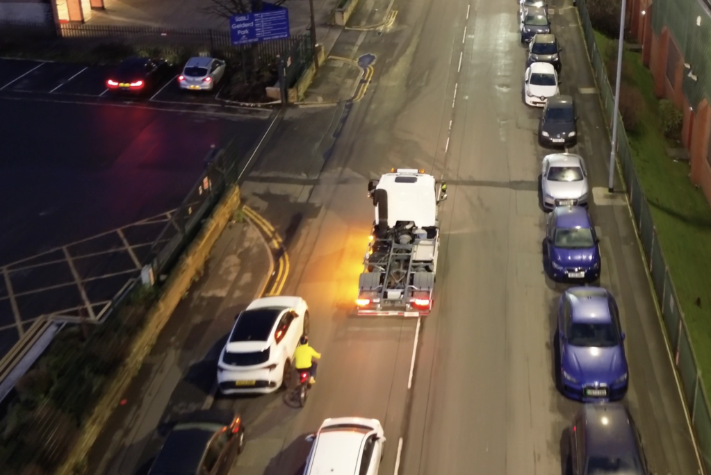 Drone shot of a truck with indicator on with Halo lamps illuminating the ground