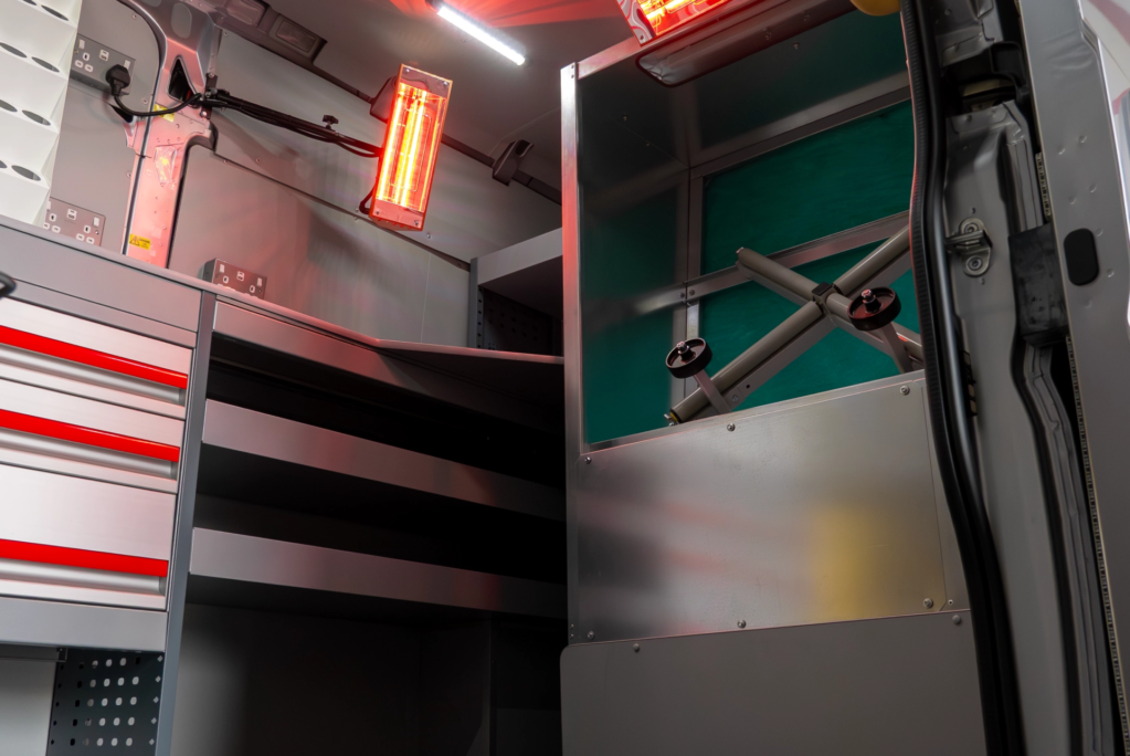 Heat lamps and spray booth area inside a SMART Repair Van